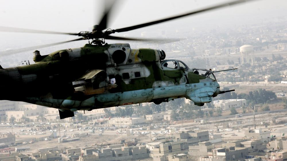 A Russian Mi-24 flies over Ad Diwaniyah, Iraq, photo by Spc. Alan Moos/U.S. Department of Defense