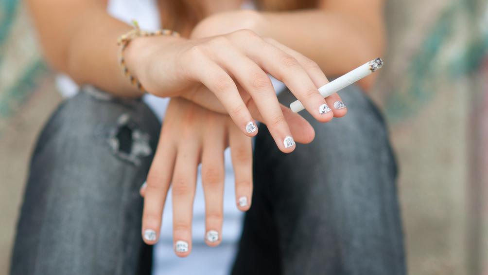 A teenager holding a cigarette, photo by Solid photos/Adobe Stock