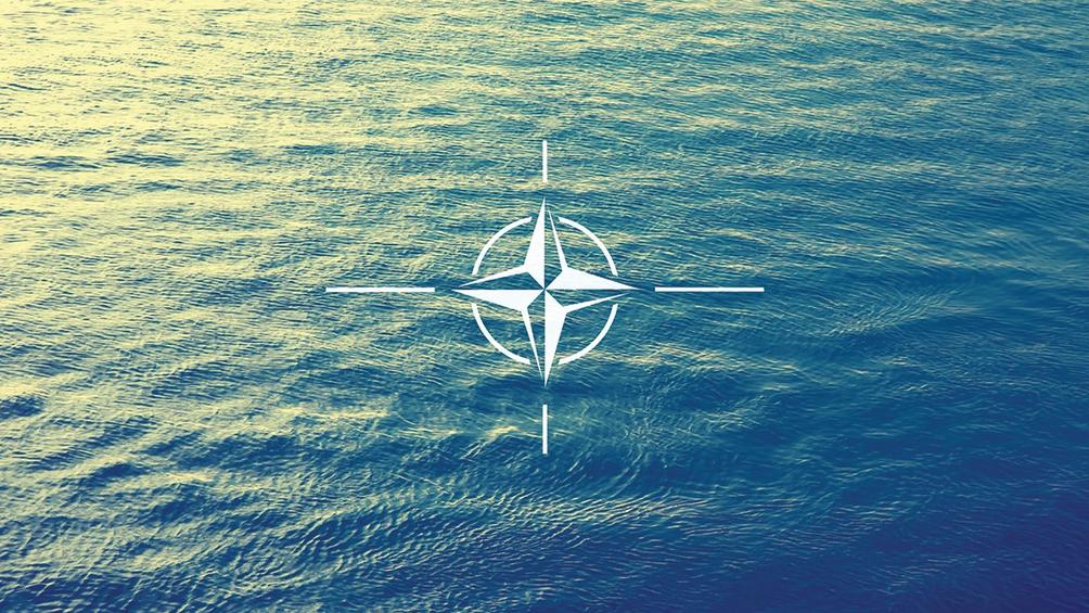 NATO flag over a blue sea, photo by Solid photos/Adobe Stock