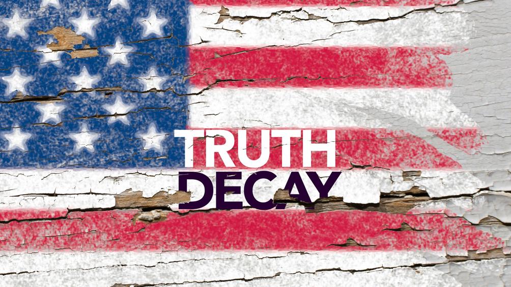 Painted American flag chipping and peeling off an old piece of wood