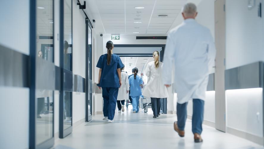 Medical staff walking down a hospital hallway
