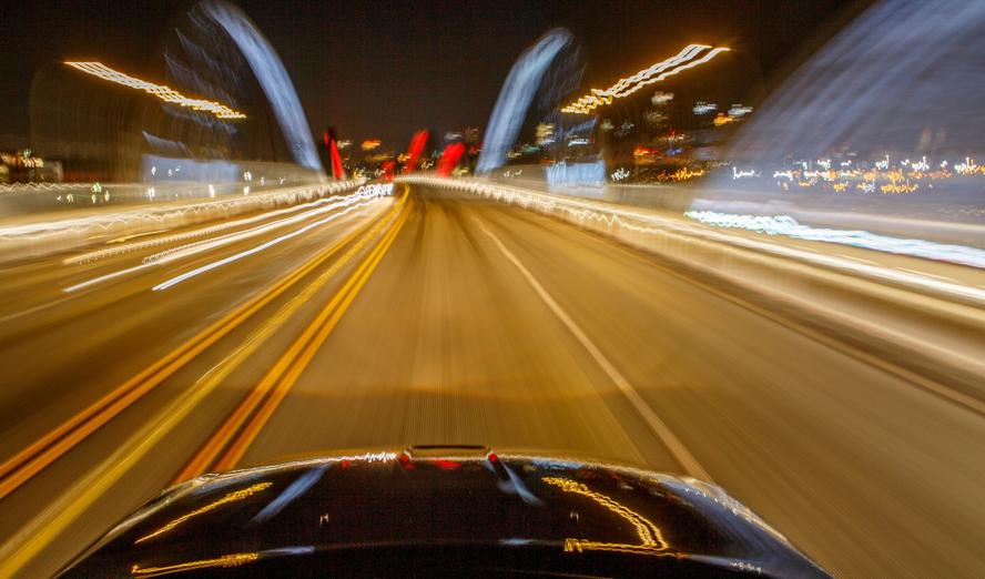 A vehicle traveling in downtown Los Angeles at night
