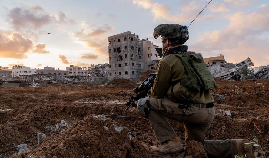 Israeli soldier takes position in the Gaza Strip amid the conflict between Israel and the Palestinian Islamist group Hamas, in this handout picture released on December 27, 2023