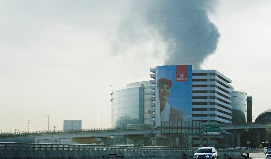 Smoke rising from an area near the Dubai International Airport, after a drone attack hit a fuel tank, according to Dubai authorities, March 16, 2026