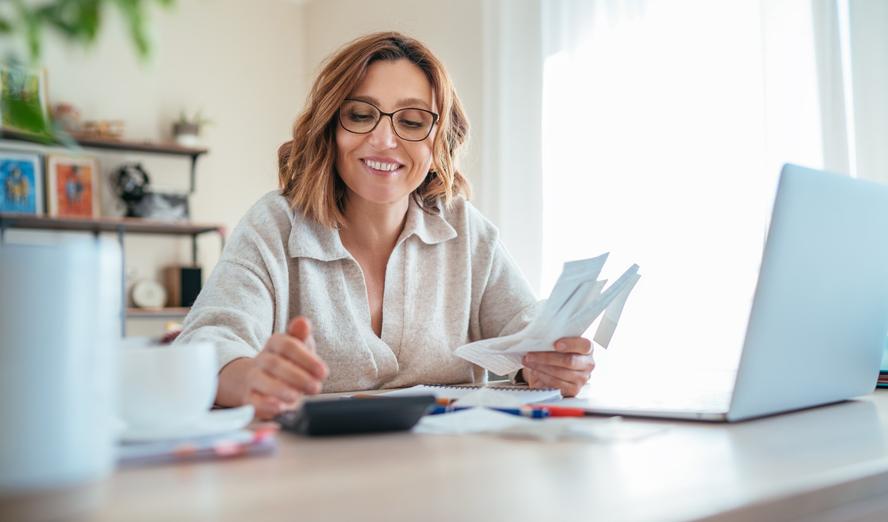 A woman managing her finances with a calculator