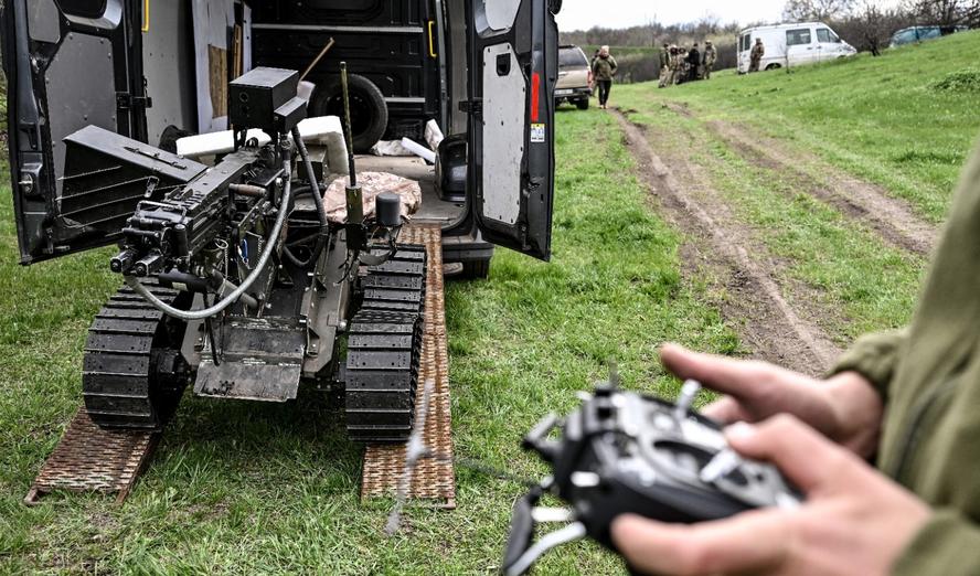 A soldier operates a ground robotic complex with a remote controller during trials at a training ground on April 10, 2026