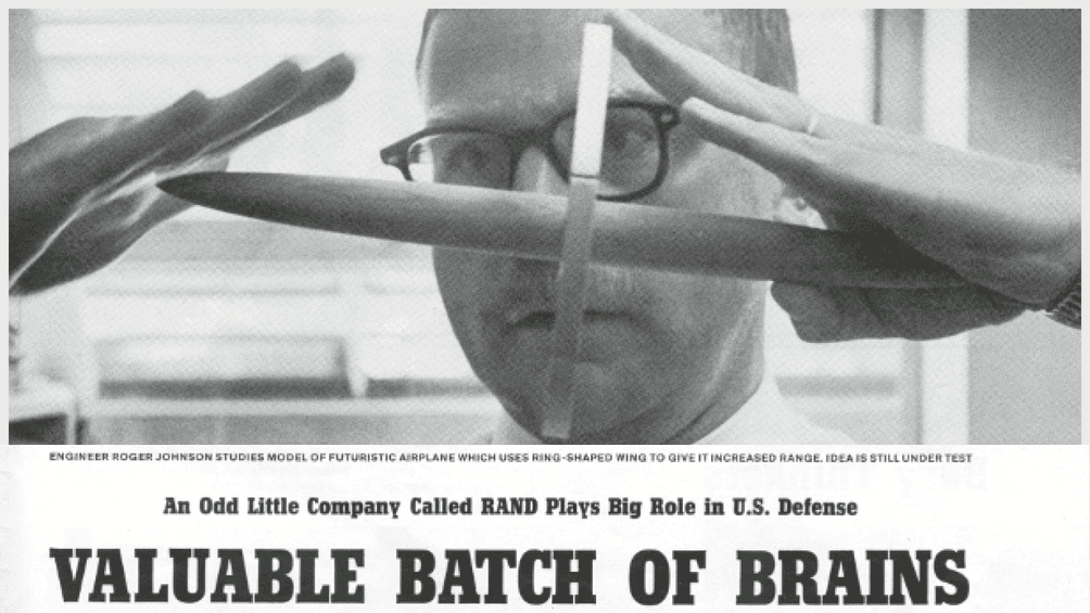 RAND researcher Roger Johnson studies model of futuristic airplane. LIFE Magazine article, 1959